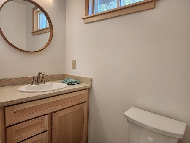 bathroom featuring toilet and vanity