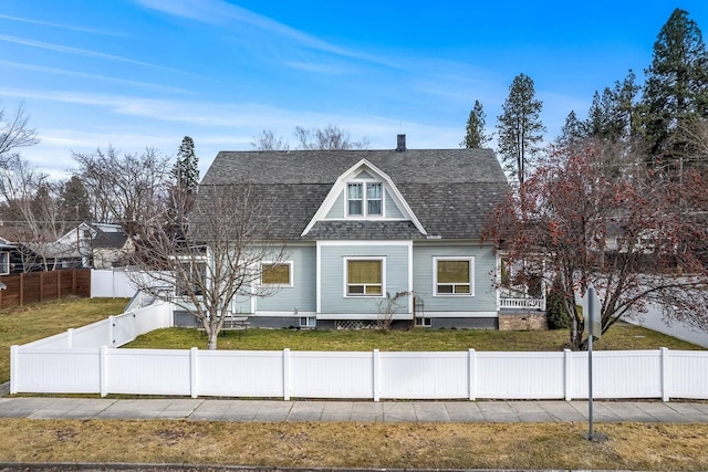 603 N 7th St, Coeur D Alene, ID 83814 - colonial inspired home featuring a gambrel roof, a fenced front yard, roof with shingles, a front yard, and a chimney