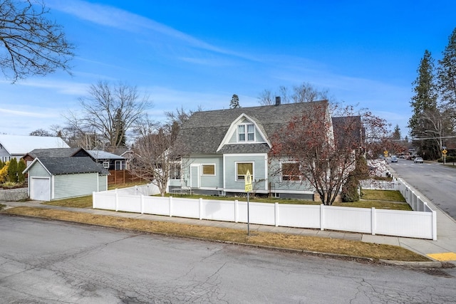 603 N 7th St, Coeur D Alene, ID 83814 - colonial inspired home featuring a detached garage, roof with shingles, an outdoor structure, and a fenced front yard