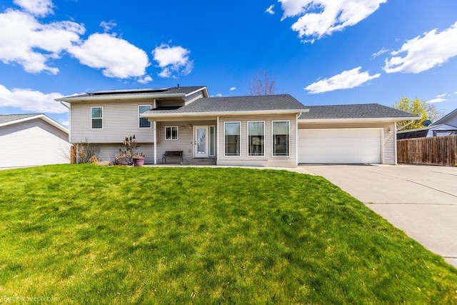 510 N Bell St, Spokane Valley, WA 99016 - view of front of home featuring solar panels, driveway, fence, an attached garage, and a front yard