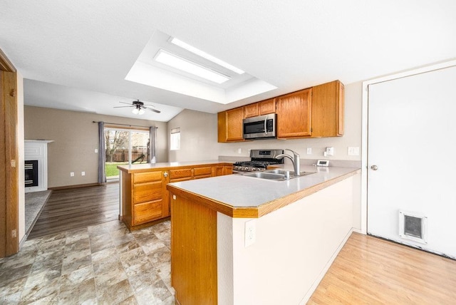 510 N Bell St, Spokane Valley, WA 99016 - kitchen with stainless steel appliances, a peninsula, a sink, visible vents, and light countertops