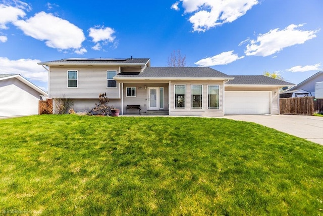 510 N Bell St, Spokane Valley, WA 99016 - split level home featuring a garage, roof mounted solar panels, a front lawn, and concrete driveway