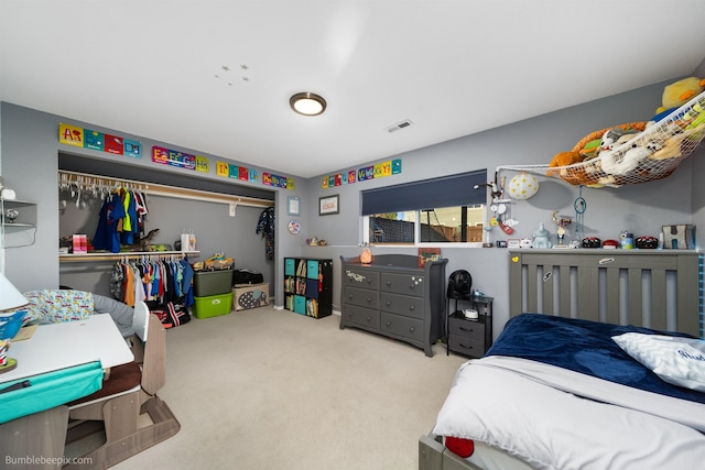 carpeted bedroom with a closet and visible vents