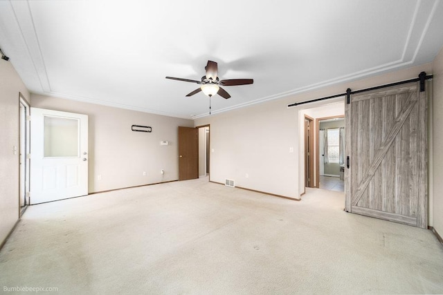 510 N Bell St, Spokane Valley, WA 99016 - empty room featuring a barn door, visible vents, a ceiling fan, ornamental molding, and light carpet