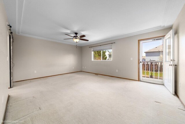 510 N Bell St, Spokane Valley, WA 99016 - spare room featuring light carpet, ornamental molding, ceiling fan, and a barn door