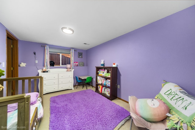 bedroom featuring baseboards, visible vents, and light colored carpet