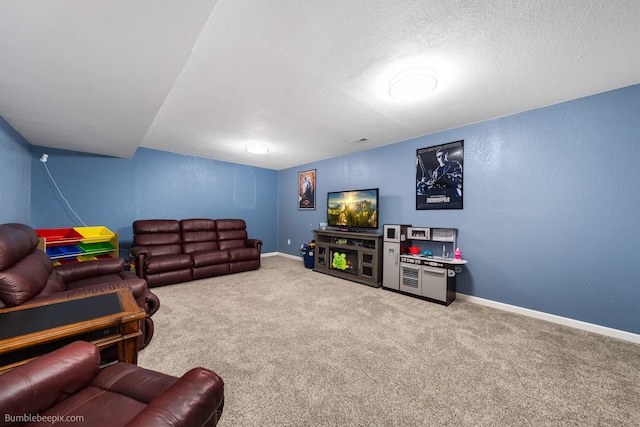 living room with a textured ceiling, a textured wall, carpet floors, visible vents, and baseboards