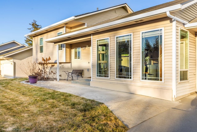 rear view of property with a patio area and a lawn