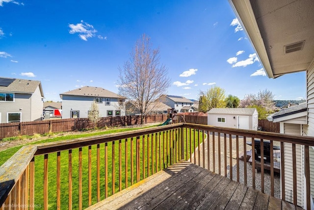 510 N Bell St, Spokane Valley, WA 99016 - deck with a residential view, an outbuilding, a fenced backyard, and a playground