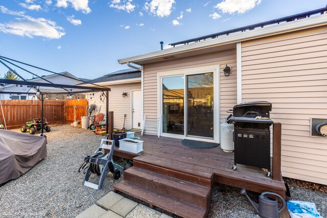 deck featuring a grill and fence