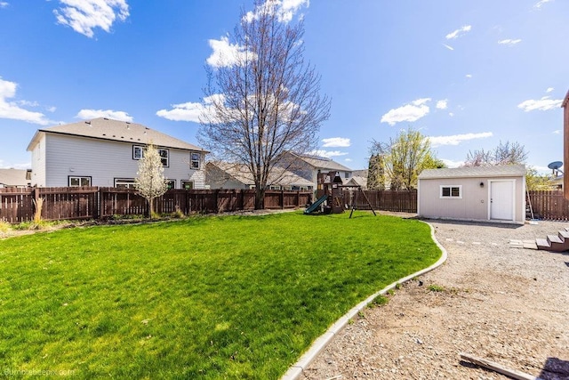 510 N Bell St, Spokane Valley, WA 99016 - view of yard featuring an outbuilding, a fenced backyard, and a playground