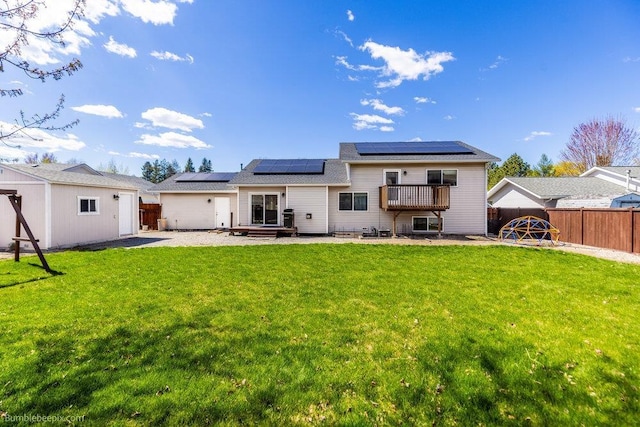 510 N Bell St, Spokane Valley, WA 99016 - rear view of property with a fenced backyard, roof mounted solar panels, a patio area, and a lawn