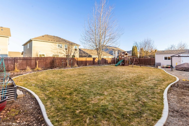 view of yard featuring a fenced backyard and a playground