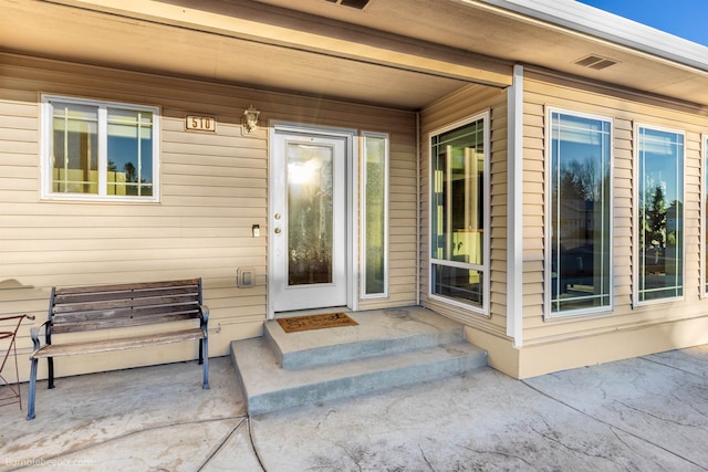 property entrance featuring a patio area