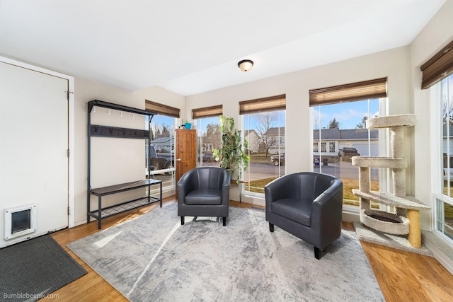 sitting room with wood finished floors and heating unit