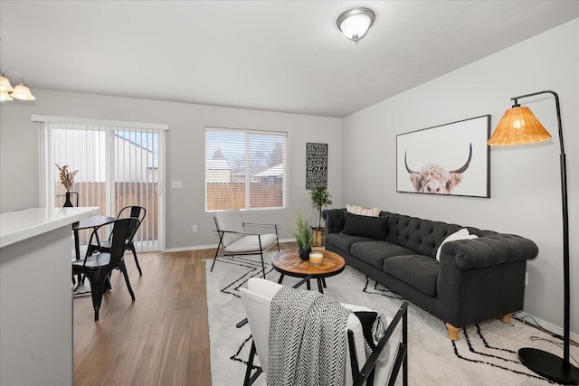 living room featuring baseboards and light wood finished floors