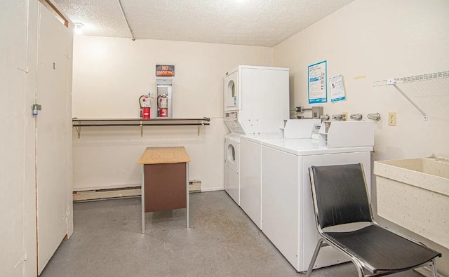 common laundry area with a baseboard heating unit, washing machine and clothes dryer, a textured ceiling, and stacked washing maching and dryer