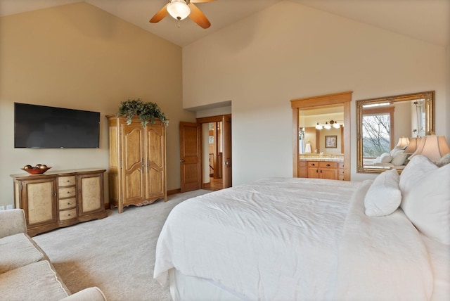 bedroom featuring ensuite bath, high vaulted ceiling, ceiling fan, and light colored carpet