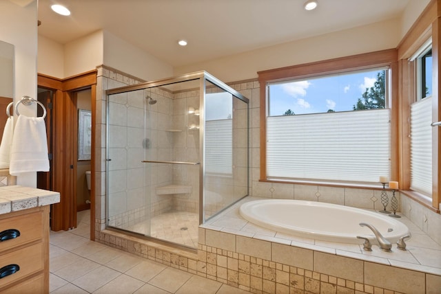 full bathroom featuring a bath, a shower stall, and a wealth of natural light