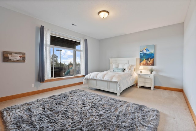 carpeted bedroom featuring visible vents and baseboards