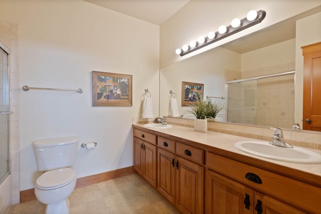 full bath with double vanity, an enclosed shower, a sink, and toilet