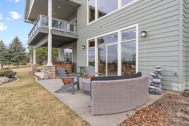 view of patio / terrace featuring a balcony and a hot tub