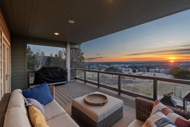 balcony at dusk featuring an outdoor hangout area and area for grilling