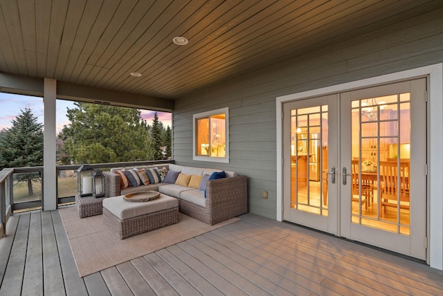 wooden terrace with outdoor lounge area and french doors