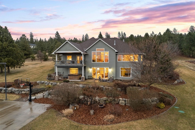 view of front of house with a yard and a hot tub