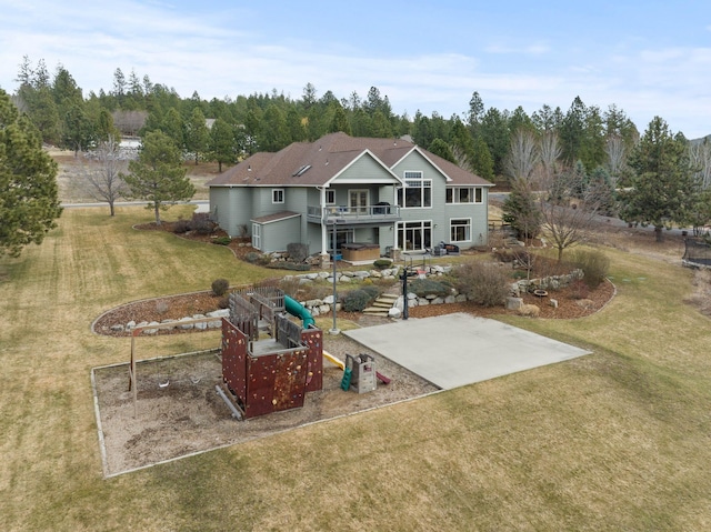 rear view of house featuring a patio and a lawn