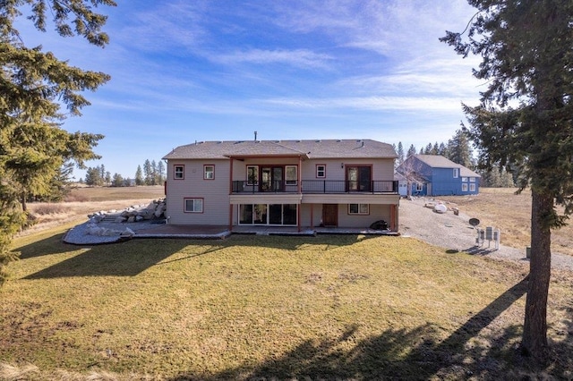 back of property featuring a lawn and a patio