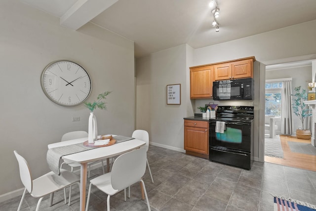 kitchen featuring brown cabinetry, dark countertops, baseboards, and black appliances