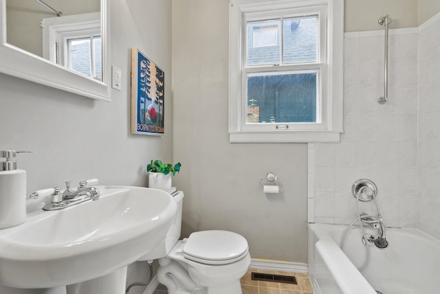 full bathroom with baseboards, visible vents, toilet, shower / tub combination, and a sink