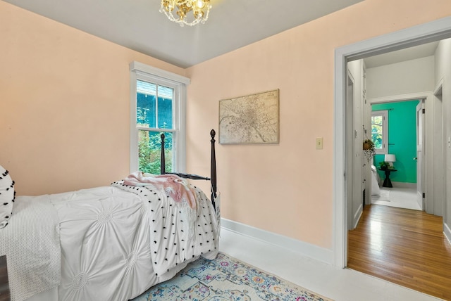 bedroom featuring baseboards and an inviting chandelier