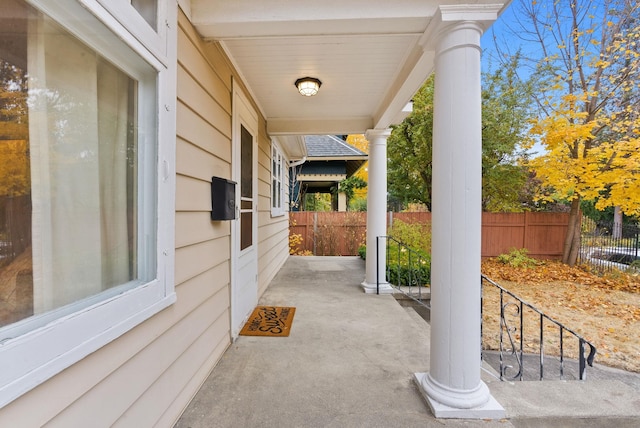 view of patio with a porch and fence