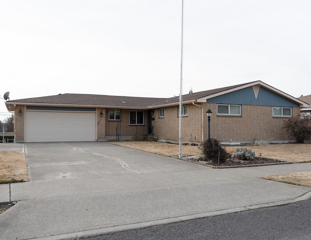 ranch-style home featuring an attached garage, driveway, and brick siding