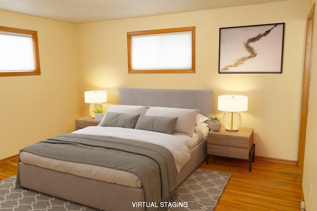 bedroom with wood finished floors and baseboards