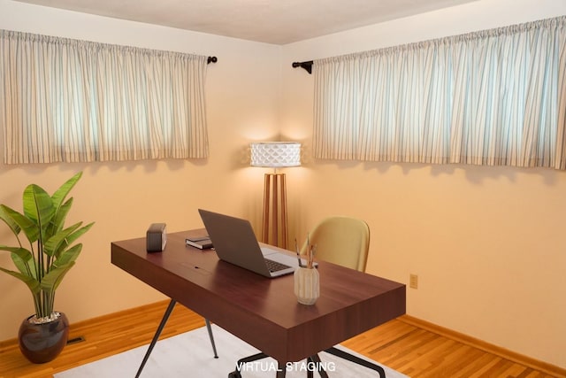 office area with wood finished floors and baseboards