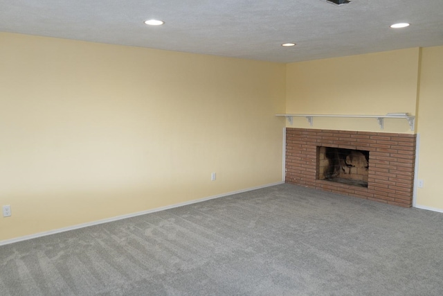 unfurnished living room featuring recessed lighting, carpet flooring, a fireplace, and baseboards