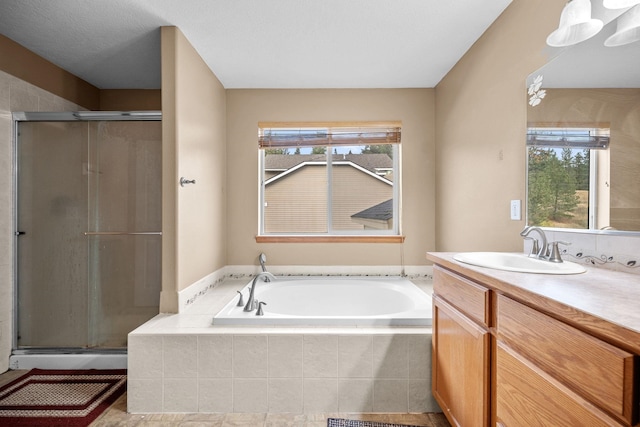 bathroom with a shower stall, a wealth of natural light, and vanity