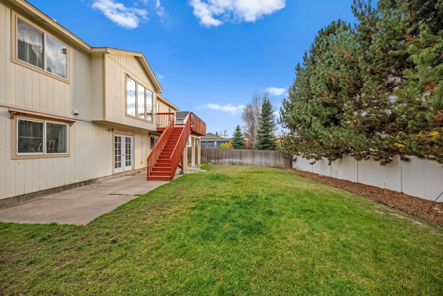 view of yard featuring a patio area, a fenced backyard, stairway, and a deck