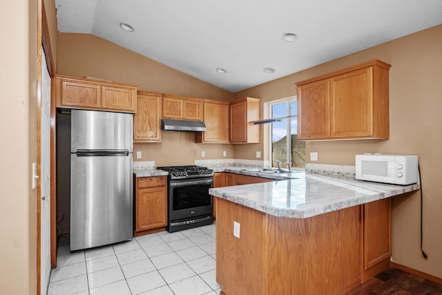 kitchen with under cabinet range hood, a peninsula, a sink, light countertops, and appliances with stainless steel finishes