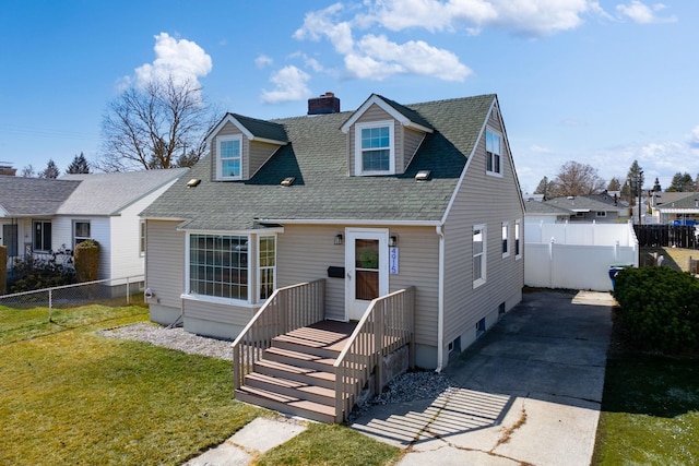 view of front of house with fence private yard, a shingled roof, a chimney, and a front yard