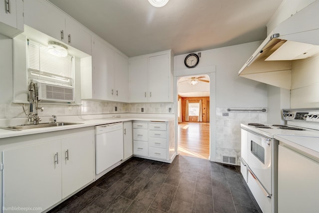 kitchen with white appliances, white cabinetry, visible vents, and light countertops