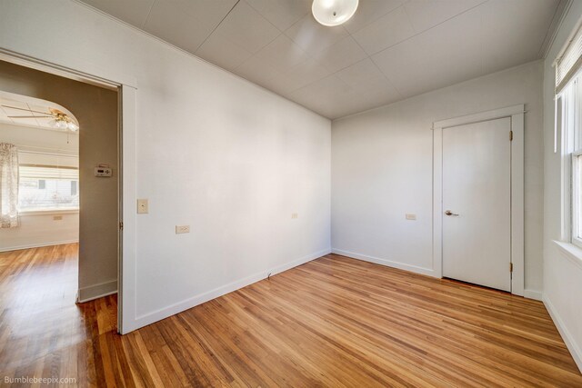 spare room with a ceiling fan, a textured ceiling, baseboards, and wood finished floors