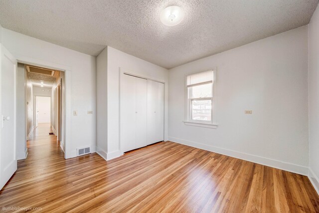 spare room with light wood finished floors and baseboards