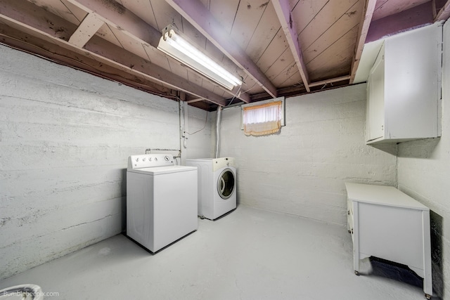 clothes washing area with cabinet space and washer and clothes dryer