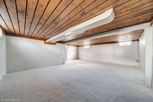 below grade area featuring wood ceiling and carpet floors
