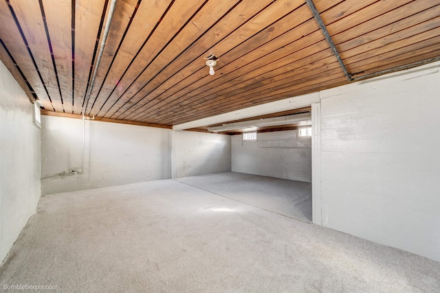 basement with wood ceiling and carpet flooring