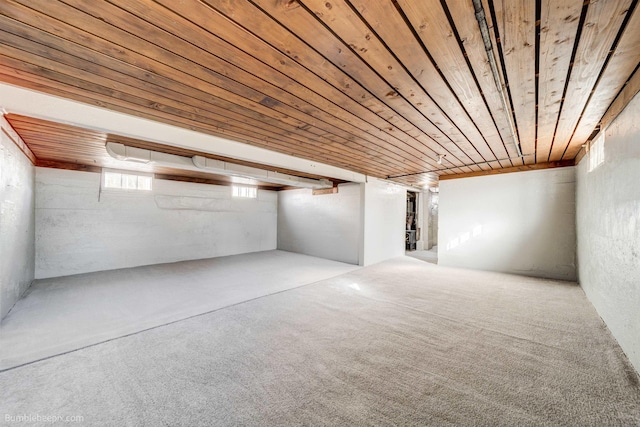 basement with wood ceiling and carpet flooring